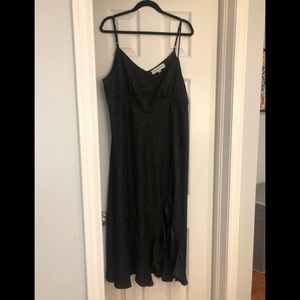 Emma & Michelle black slip dress with side slit and adjustable spaghetti straps.